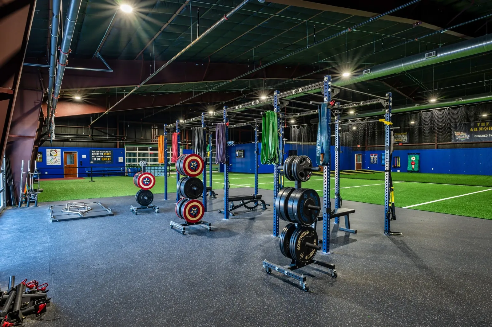 Squat racks, platforms, and bumper plates on the group training floor