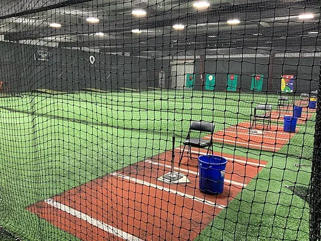 Hitting stations with tees and target nets in the development cages