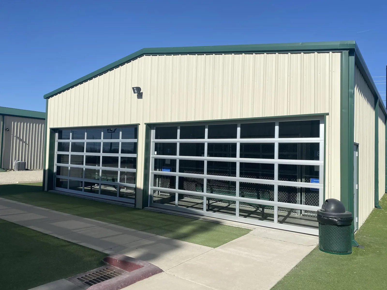 Glass bay doors on the team cage building
